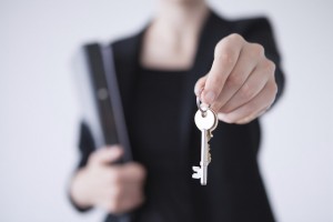 a real estate agent holding house keys